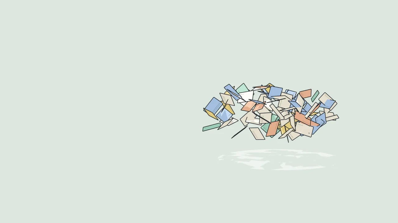 A drawing of a whole deck of revision cards, some in pastel colours, hanging in the air over a pale green table.
